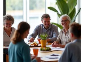 A diverse group of adults intently participating in a wellness workshop, possibly discussing nutrition or health, in a modern, inviting space.